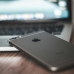 space gray iPhone 6 on MacBook laptop