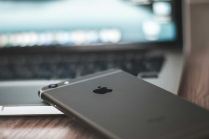 space gray iPhone 6 on MacBook laptop